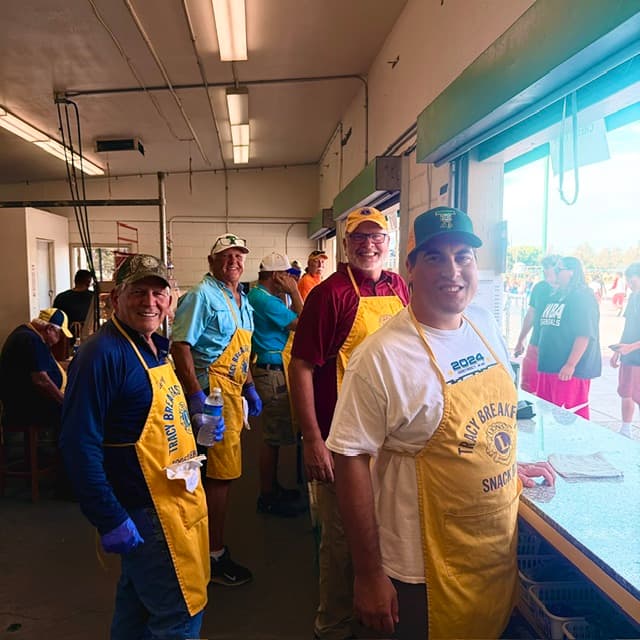 Volunteers working together inside a football concession stand.